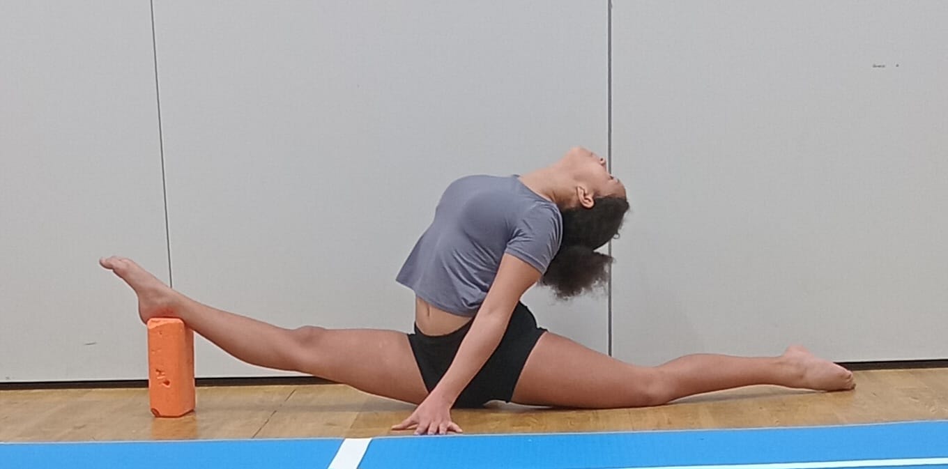 Student performing splits with flexibility block
